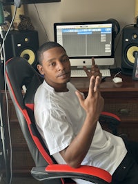 a man sitting in a chair in front of a computer